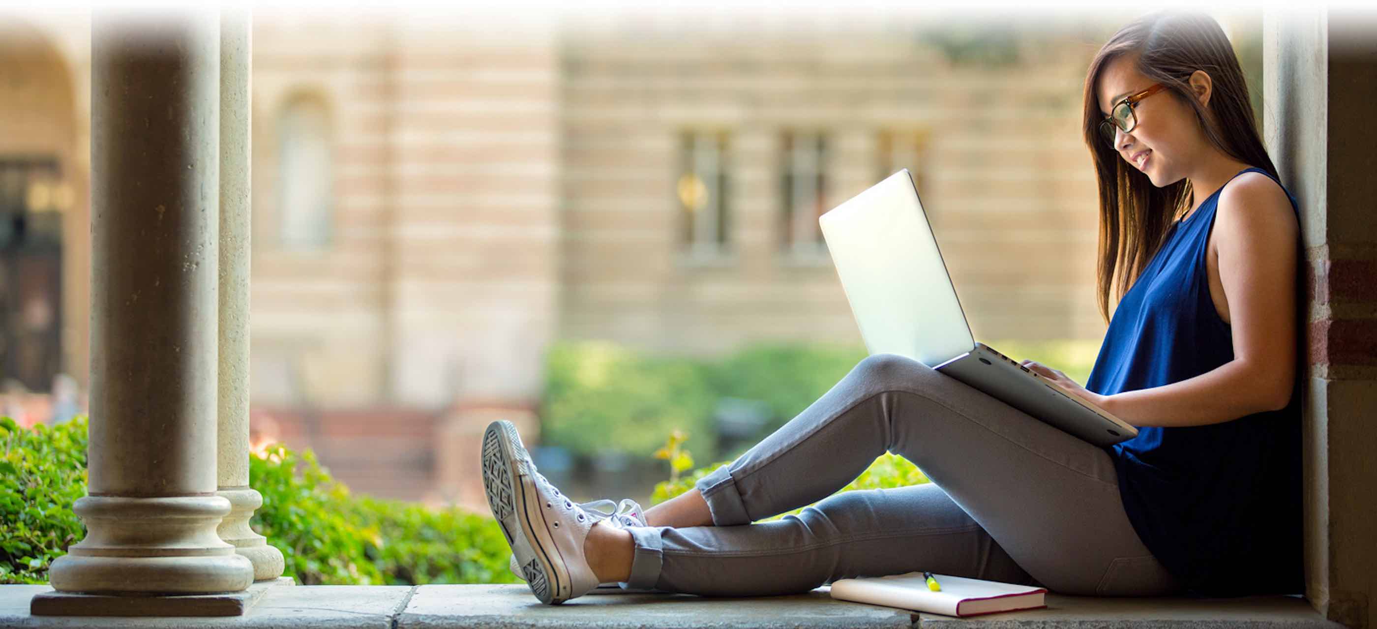 college student looking at laptop